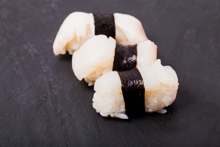 Hotate nigiri sushi set on black slateの写真素材