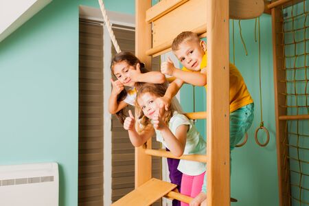 Portrait of three friends hanging on wooden bars