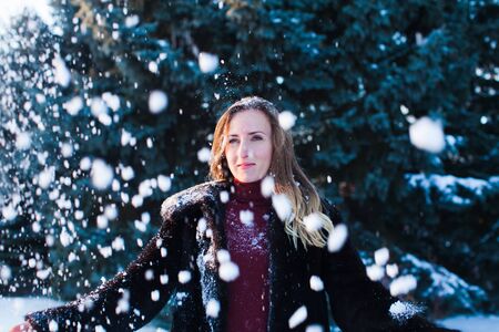 The beautiful woman in winter pine woodの写真素材