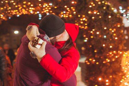Young couple kissing outdoors at Christmas fairの写真素材