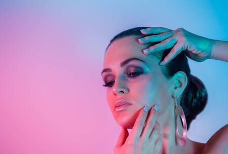 Make up and Beauty Woman under the neon pink and blue lightの写真素材