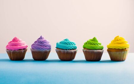 Vivid colous cupcake in a row. Different choices during the lifeの写真素材