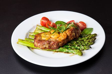 Gourmet steak with green asparagus. Concept for a tasty and healthy meal. Close up.の写真素材