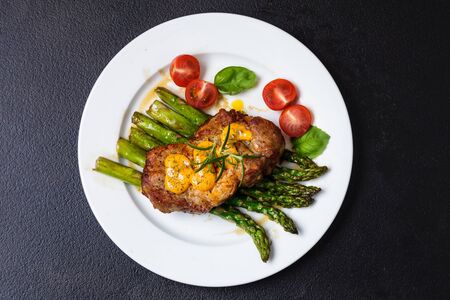 Gourmet steak with green asparagus. Concept for a tasty and healthy meal. Close up.の写真素材