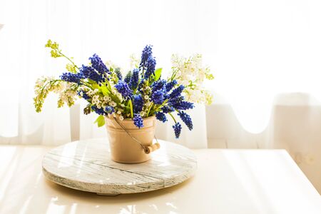 Bunch of grape hyacinths in a ceramic vase