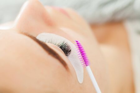 Woman Eye close up during the Eyelash Extensionの写真素材