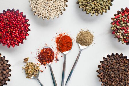 milled and whole peppercorns, various spicy peppers