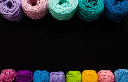 Top view heap of textile yarn balls on the blackの写真素材