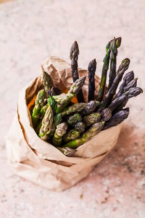 Bunch of fresh purple asparagus spears standing verticalの写真素材