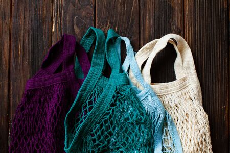 Cotton eco mesh bags on dark wooden background