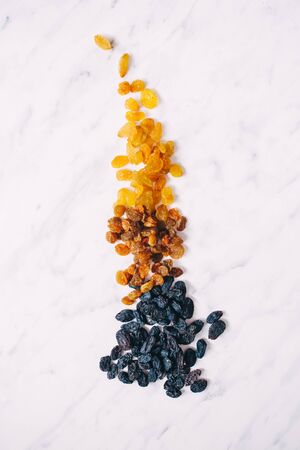 Dried raisins on a white marble backgroundの写真素材