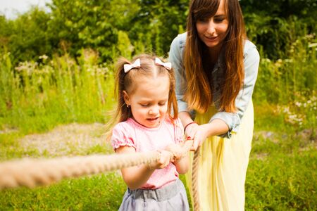Happy mother and daughter having fun together on natureの写真素材