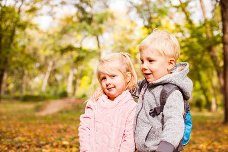 Children on a walk in autumn parkの写真素材