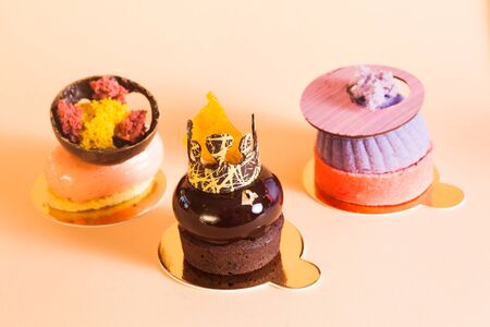 French mousse cakes covered with mirror glaze. Modern european cake pastry with decorations. Europen patisserie shop backgroundの写真素材