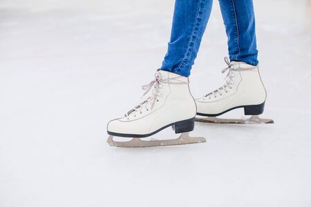 Young woman is skating on the rinkの写真素材