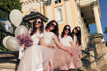 Stylish bridesmaids and bride posing outdoors on summerの写真素材