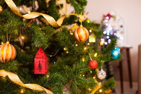 Closeup of toy decorations which are located on a stylish Christmas tree