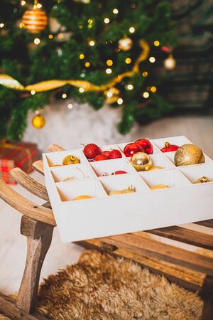 Box with golden and red baubles for Christmas treeの写真素材