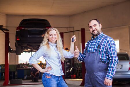 Client and car service owner standing togetherの写真素材