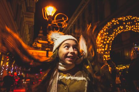 Happy girl look around at the christmas marketの写真素材