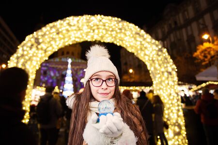 Pretty girl make a wish at magic new year night in christmas marketの写真素材