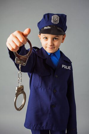 Little boy pretending to be a police officer.