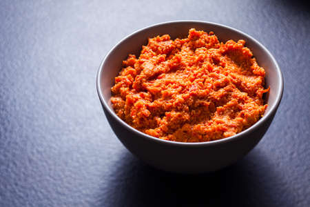 Bowl with cashews dipping sauce on dark grey surfaceの写真素材