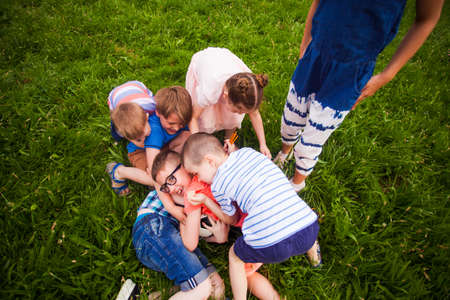 The kids having fun playing with a ball in the park