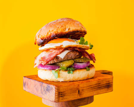homemade chicken burger with bacon and fried eggの写真素材