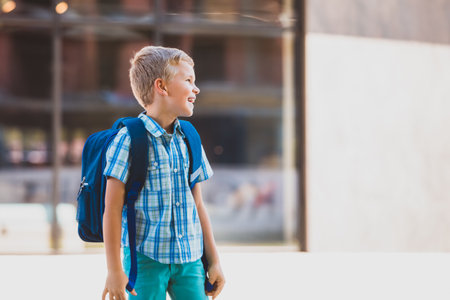 Cute boy going to school with backpackの写真素材