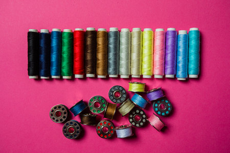 Assortment of multicolor threads in bobbins and spools