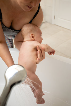 Using shower for infant instead of taking a bathの写真素材