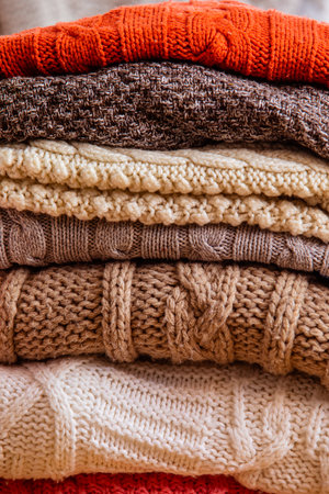Pile of woolen clothes close up as a backgroundの写真素材