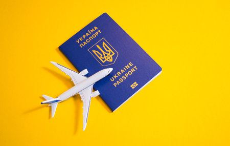 Kyiv, Ukraine - November 25, 2020: Closeup Ukrainian Biometric passport with toy plane nearのeditorial素材