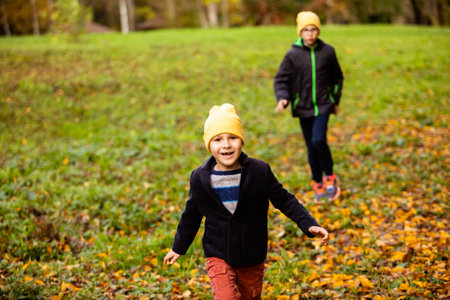 Two friends are walking in the autumn park