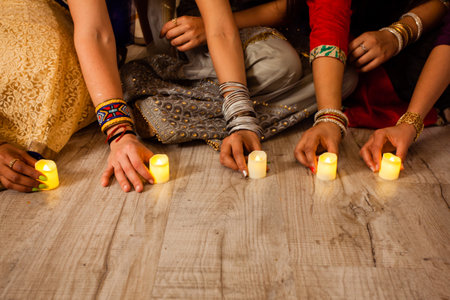 Lighting candles and oil lamps as part of Diwali traditionsの写真素材