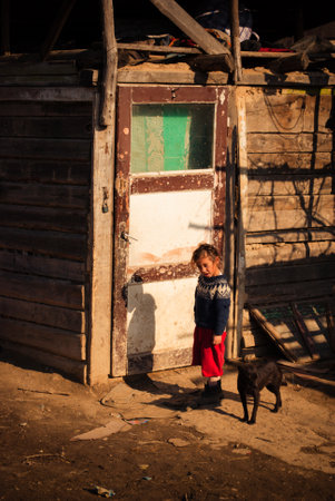 SEREDNIE, UKRAINE - MARCH 09, 2011: Romani child near self-made homeのeditorial素材
