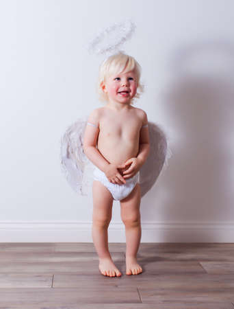 the baby with angel wings and nimbus indoorsの写真素材