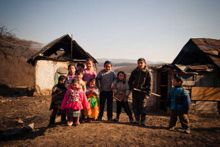 SEREDNIE, UKRAINE - MARCH 09, 2011: kids are happy not paying attention to surrounding poornessのeditorial素材
