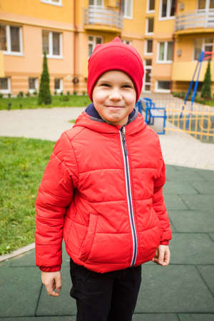 Boy strengthens his body climbing on outdoor playgroundの写真素材