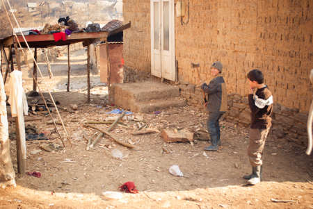 SEREDNIE, UKRAINE - MARCH 09, 2011: Kids performing adult chores and reponsibilitiesのeditorial素材