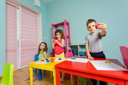 the child enjoys his work at the kindergartenの写真素材