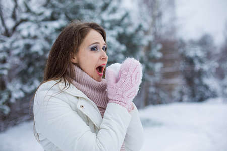 woman who feels like a child is having fun in winterの写真素材