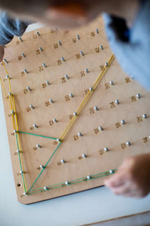 Exploring basic math and geometry concepts with geoboardの写真素材