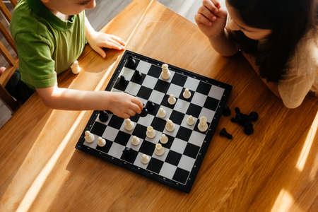 Top view boy and girl playing chessの写真素材