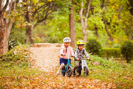 Fearless and active girl on a balance bikeの写真素材