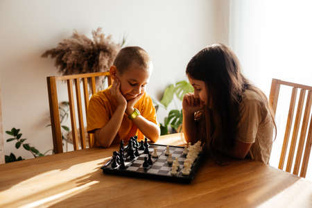 Kids having great time together playing chessの写真素材