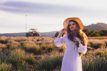 Portrait of woman is standing among the plantations of lavenderの写真素材