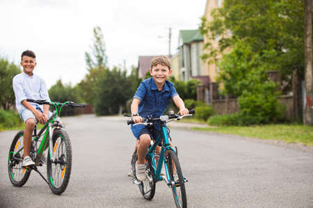The friends on bicycles greet each other on the streetの写真素材