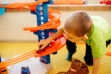The cute child is playing with toy cars at homeの写真素材